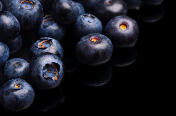 Several whole blueberries isolated on black corner — Stock Photo, Image