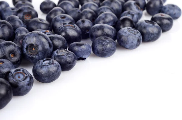 Several whole blueberries isolated on white corner — Stock Photo, Image