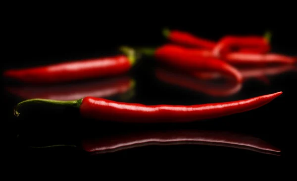 Studio skott av chili peppers på svart — Stockfoto