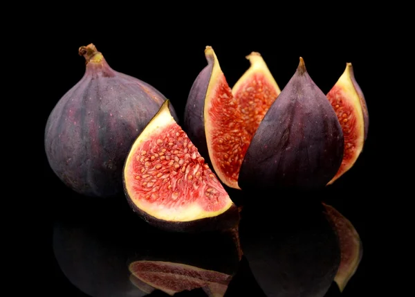 Three figs split like flower isolated on black background — Stock Photo, Image