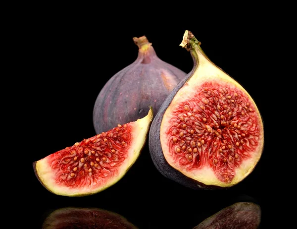 Three sliced figs isolated on black background — Stock Photo, Image