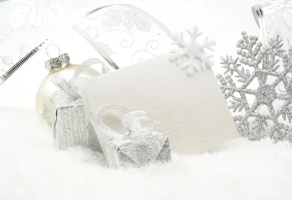 Silver christmas decoration on snow with wishes card — Stock Photo, Image