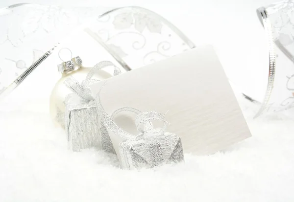 Silver christmas decoration on snow with wishes card Stock Photo
