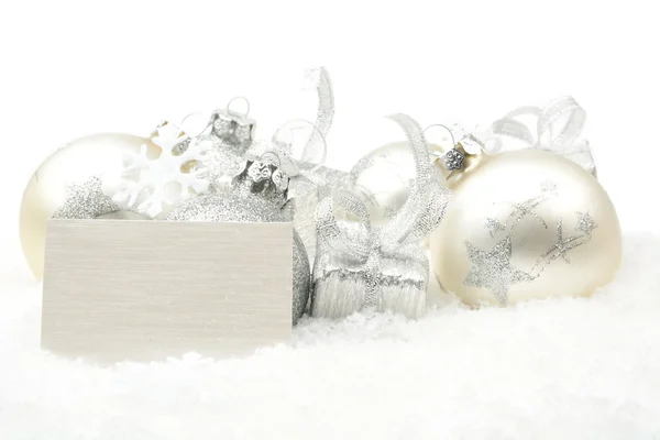 Decoración de Navidad de plata en la nieve con tarjeta de deseos en línea —  Fotos de Stock