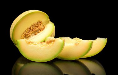 Melon galia notched with slices isolated black in studio clipart