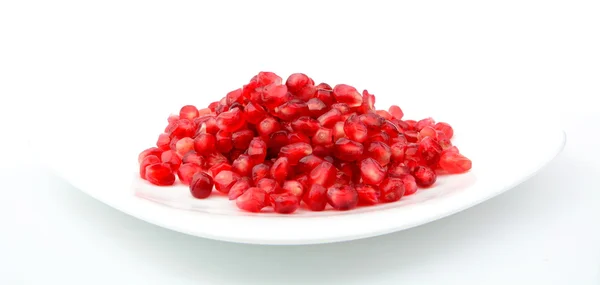 Studio shot open pomegranate on plate isolated on white — Stock Photo, Image