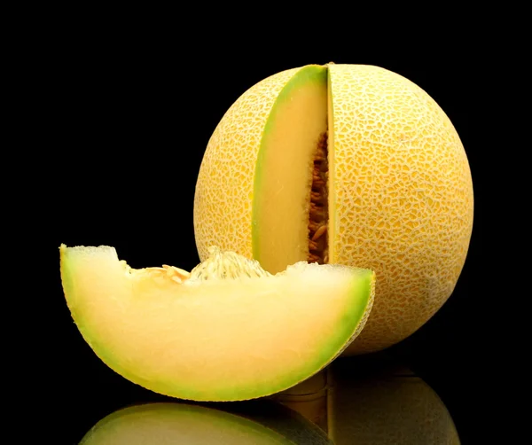 Melon galia notched with slice isolated black in studio — Stock Photo, Image