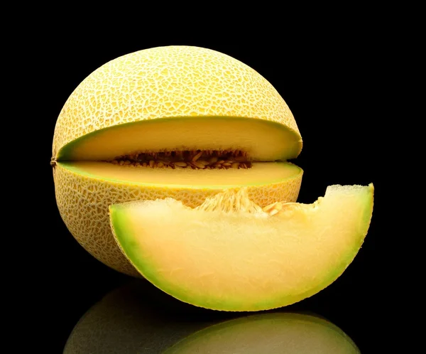 Melon galia notched with slice isolated black in studio — Stock Photo, Image