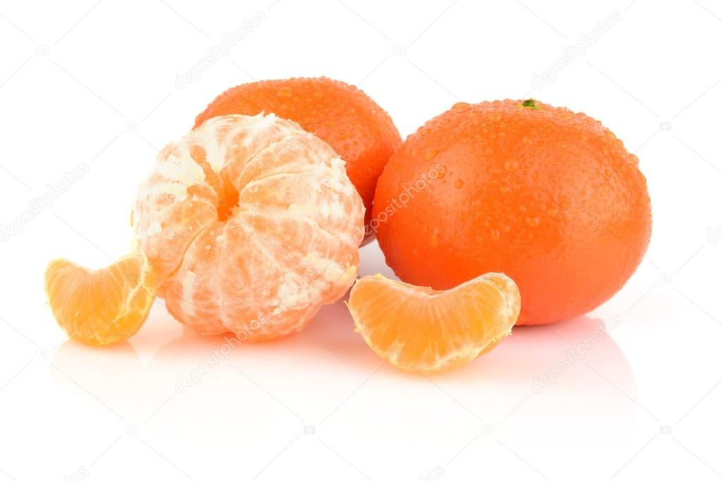 Studio shot dewy peeled mandarines isolated on white