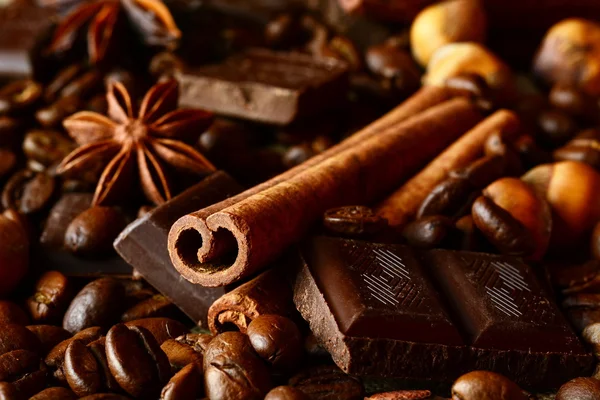 Aromatic assortment of chocolate,coffee,anise, and cinnamon on l — Stock Photo, Image