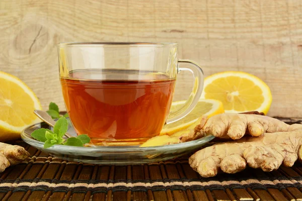 Ginger tea-ingwertee on brown mat with lemon — Stock Photo, Image
