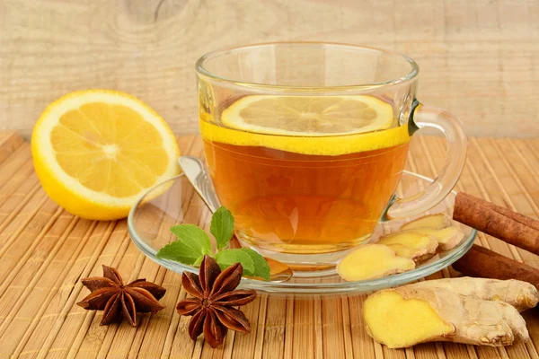 Ginger tea-ingwertee on wooden mat with lemon — Stock Photo, Image