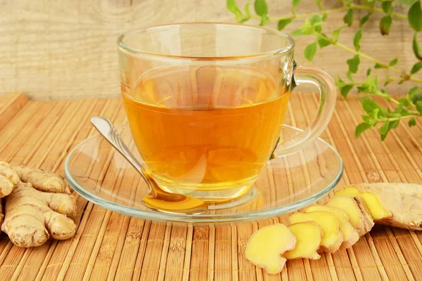 Ginger tea-ingwertee on wooden mat — Stock Photo, Image
