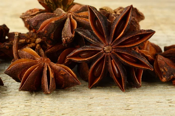 Macro view of many anise on wooden board — Stock Photo, Image