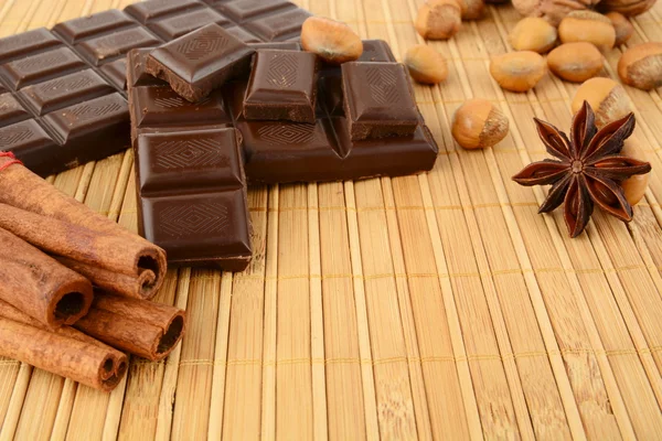 Romantic set of chocolate,anise and cinnamon on wooden mat — Stock Photo, Image