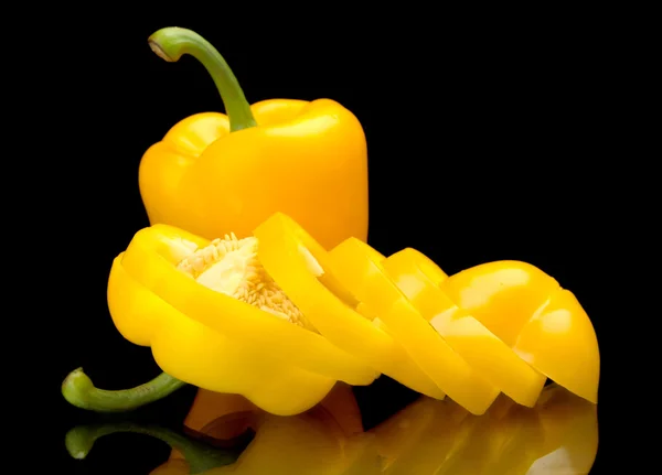 Closeup slices of yellow bell peppers isolated on black — Stock Photo, Image