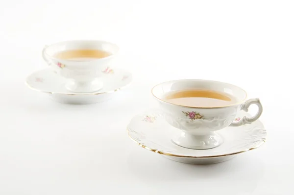 Old-style vintage two cups of tea on white background — Stock Photo, Image