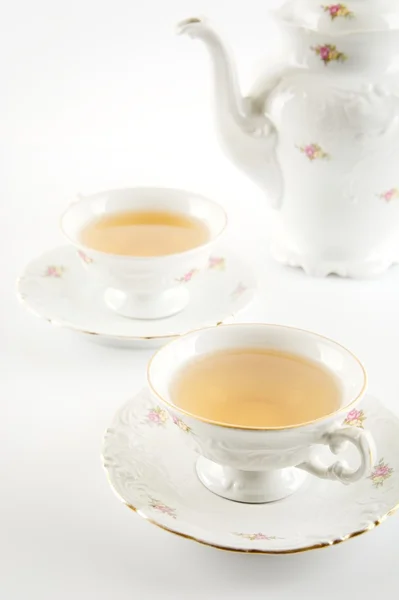 Old-style kettle with two cups of tea on white background — Stock Photo, Image