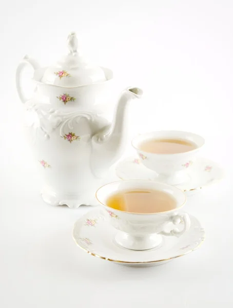 Old-style kettle with two cups of tea on white background — Stock Photo, Image