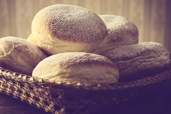 Closeup shot of doughnuts in wicker basket vintage effect — Stock Photo, Image