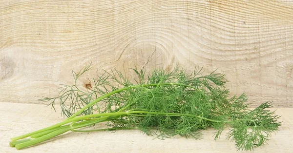 Dill leaves on wooden planking background — Stock Photo, Image