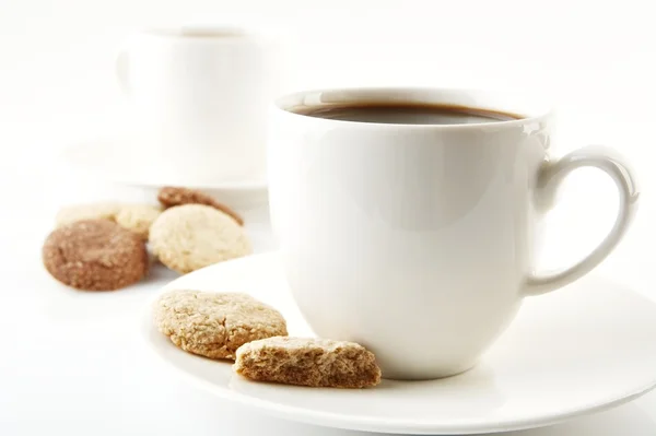 Cups of coffee with cookies and saucer on white — Stock Photo, Image