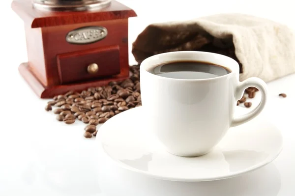 Cup of coffee with mill,bag full of coffee beans on white — Stock Photo, Image