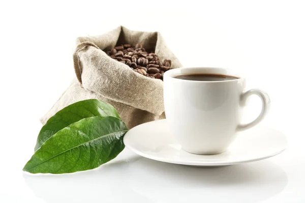 Sack full of coffee beans with green leaf and coffee cup — Stock Photo, Image