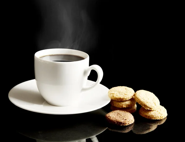 Cup of coffee with cookies and saucer on black — Stock Photo, Image