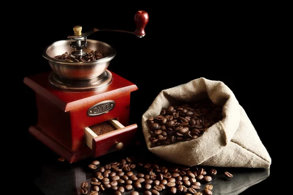 Sack full of coffee beans with mill — Stock Photo, Image