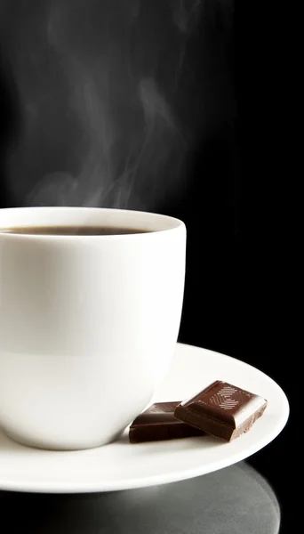 Cup of coffee with chocolate and saucer on black — Stock Photo, Image