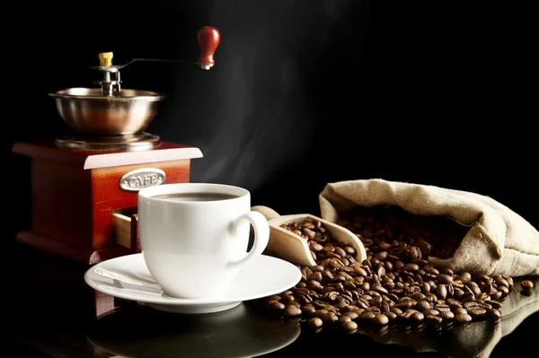 Cup of coffee with saucer,bag,coffee beans on black — Stock Photo, Image