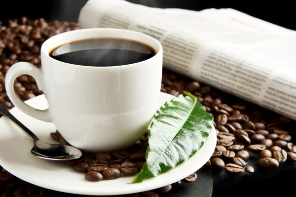 Cup of coffee with haze with newspaper,coffee leaf at breakfast — Stock Photo, Image