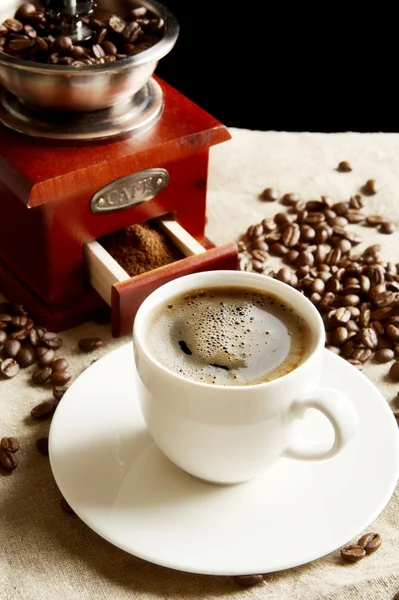 Cup of coffee with bag,coffee beans on flax linen — Stock Photo, Image