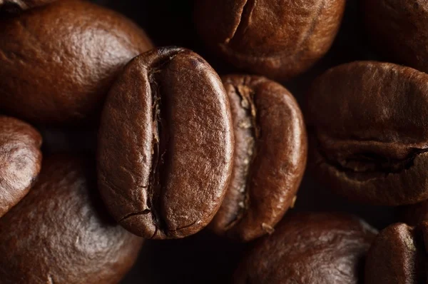 Macro shot of coffee roasted beans background — Stock Photo, Image