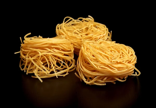 Group of three round balls of raw pasta on black — Stock Photo, Image