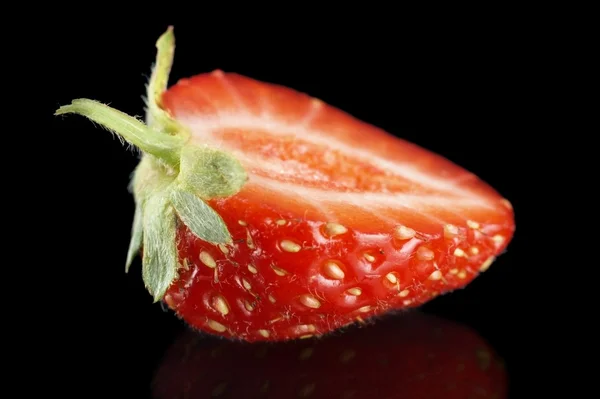 Macro side view of half of strawberry isolated on black — Stock Photo, Image