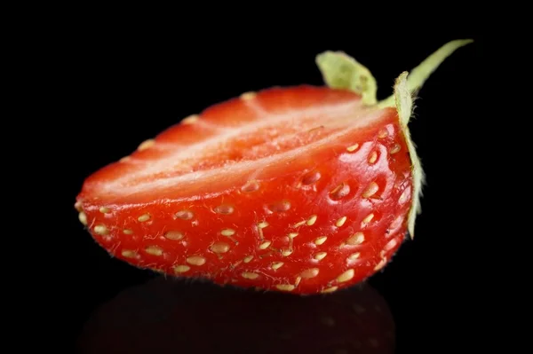 Makro yan çilek izole üzerinde siyah yarısı görüntülemek — Stok fotoğraf