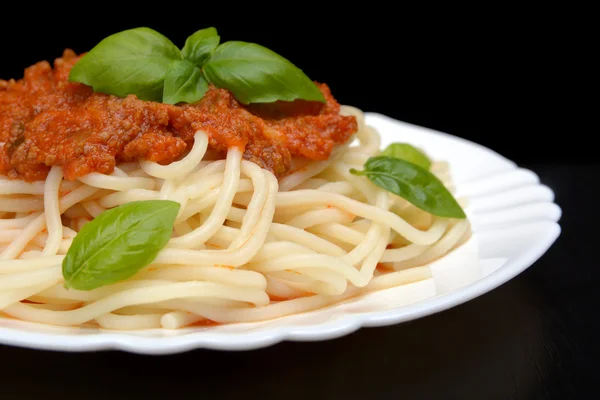 Close up pasta with bolognese sauce on black,cropped shot — Stock Photo, Image