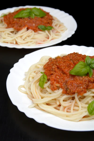 Two dish pasta with bolognese sauce on black — Stock Photo, Image