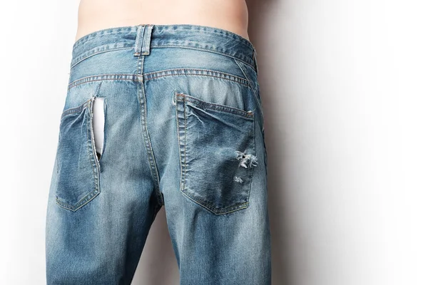 A man wear jeans with trace of theif slitting on it — Stock Photo, Image