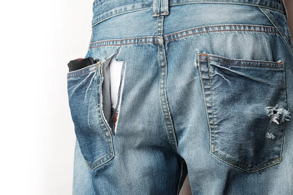 A man wear jeans with trace of theif slitting on it — Stock Photo, Image