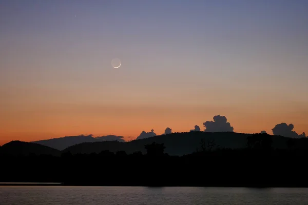 Moonrise behind the lake and hill — Stock Photo, Image