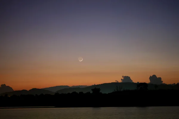 Moonrise behind the lake and hill — Stock Photo, Image