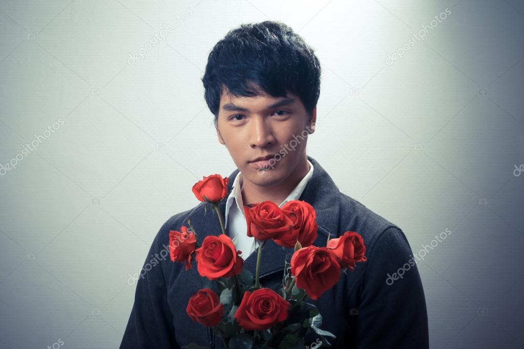 Asian guy with red roses in retro style