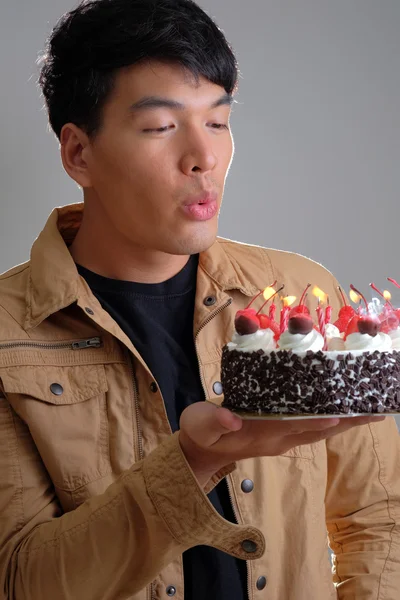 Asian man with birthday ice-cream cake on fire — Stock Photo, Image