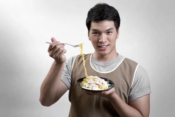 Hombre asiático comiendo espaguetis carbonara —  Fotos de Stock