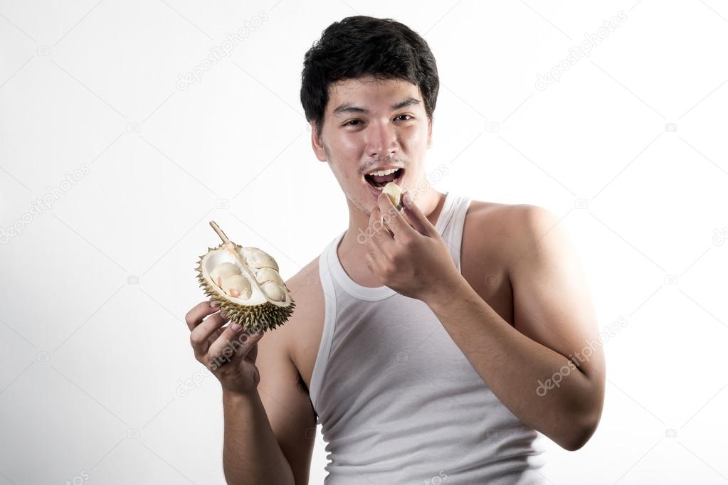 Asian man eating Durian