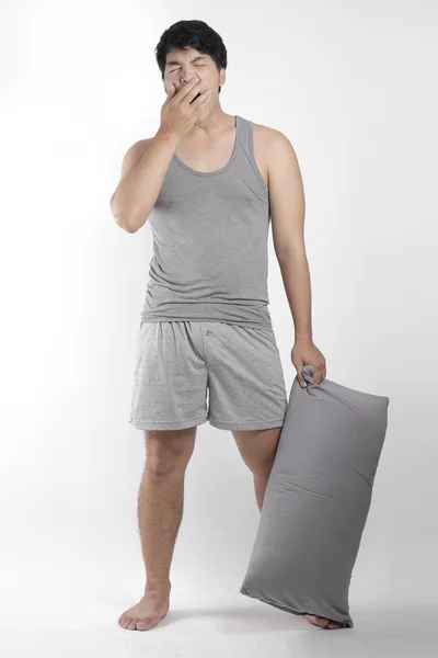Asiático chico en gris pijama con una almohada —  Fotos de Stock