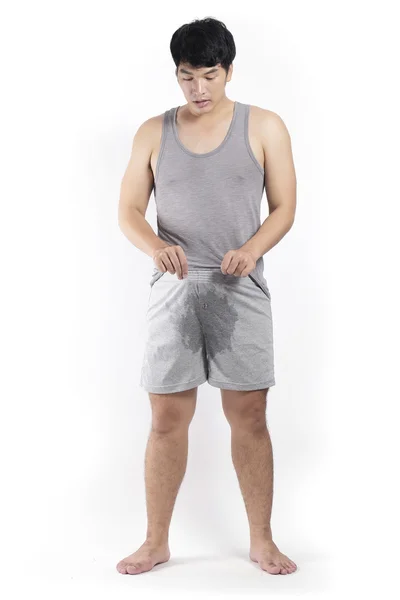 Asian man in grey pajamas with wet crotch — Stock Photo, Image